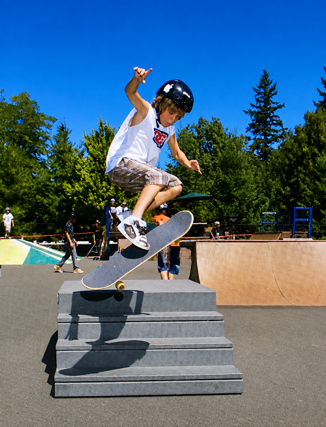 Skater ollie over cones in a parking lot